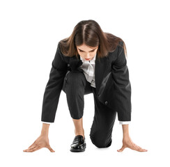 Young businesswoman standing in crouch start position isolated on white background