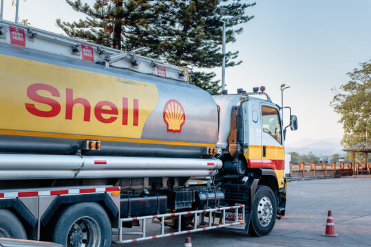 Chiang Mai, Thailand - Dec 15, 2020: Shell Gas Station and Trailer Truck During Sunset. Royal Dutch Shell Oil and Gas Industry Production, Refining, Transport, Marketing, Petrochemical and Trading.