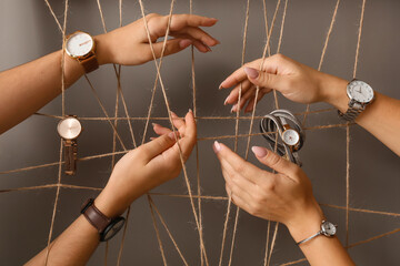 Fototapeta na wymiar Female hands with stylish watches and ropes on grey background