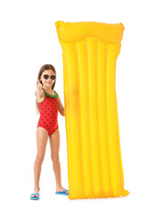 Cute little girl with inflatable mattress showing thumb-up gesture on white background