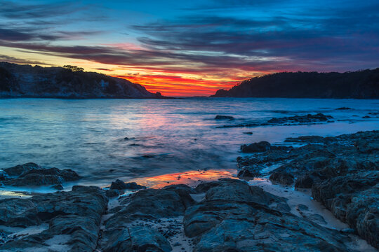 Colourful High Cloud Sunrise Seascape and Rock Formations © Merrillie