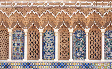 Colorful oriental windows with tiles and carved floral ornaments
