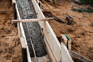 Timber formwork with metal reinforcement for pouring concrete and creating a solid foundation for a...