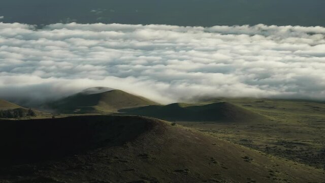 Hawaii "The Big Island" cloudy tropical flow travelling above the hills viewed from Mauna Kea - Time lapse