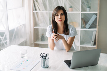 Office relocation. Real estate. Property rent. Confident female manager working remotely with...