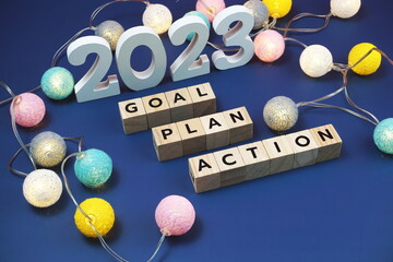2023 Goal, Plan, Action alphabet letter decorate with LED cotton ball on blue background