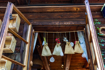 Linen pouches with medicinal herbs hanging in the window of the house