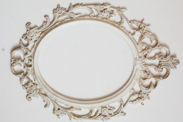 White stylish baroque frame with copy space isolated on white wall