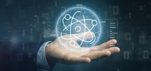 Businessman holding an atom icon surrounded by data