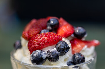 Sweet dessert - meringue with strawberries and blueberries