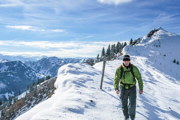 Fototapeta na wymiar Wanderer am verschneiten Gipfelgrat am Stuiben im Allgäu