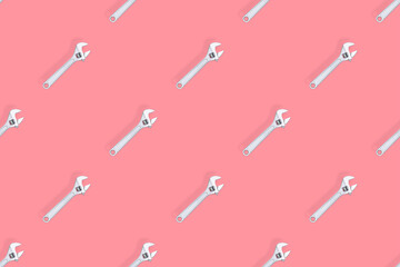 Adjustable metal wrench seamless pattern. Adjustable metal wrench on a colored background.