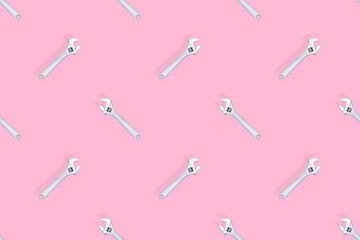 Adjustable metal wrench seamless pattern. Adjustable metal wrench on a colored background.