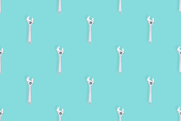 Adjustable metal wrench seamless pattern. Adjustable metal wrench on a colored background.