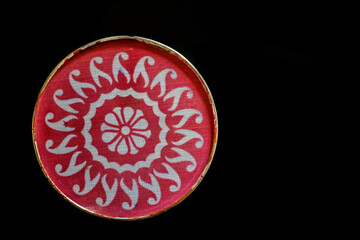 Picture of round shape rangoli stencil ,on black background.