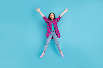 Fototapeta na wymiar Full size portrait of attractive lady jumping star shape open mouth plaid magenta outfit isolated on blue color background