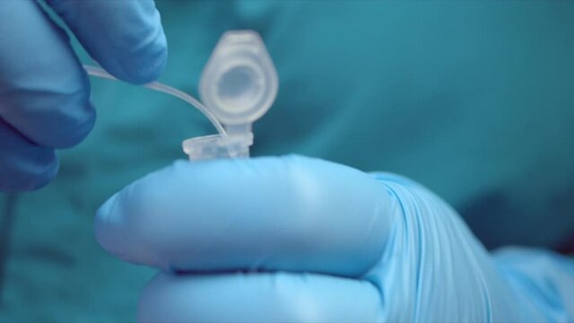 Man puts swab with coronavirus smear sample into container