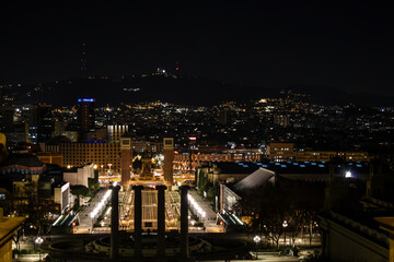 Fototapeta na wymiar Plaza España in Barcelona photographed at night illuminated by streetlights and buildings.