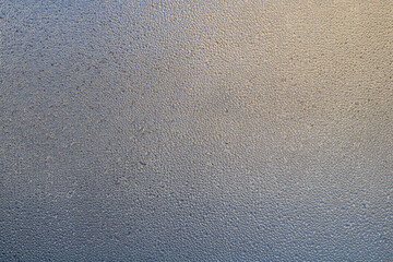 Details of the moisture condensation on the clear glass window. Abstract background texture. Hot water vapor condenced. Close up