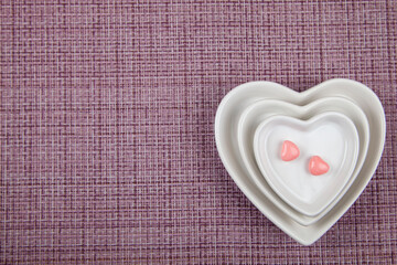 Plates with the shape of a heart and two sweets