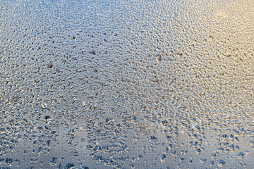 Details of the moisture condensation on the clear glass window. Abstract background texture. Hot water vapor condenced. Close up