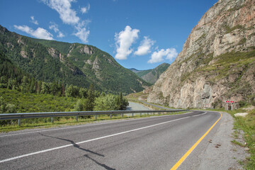 Fototapeta premium Summer view. Asphalt road passes through the gorge, Chuiski tract, Altay. 