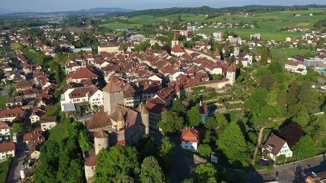 Aerial drone footage of the medieval Murten (Morat in French) old town in Canton Fribourg in Switzerland with a rotation and tilt down motion