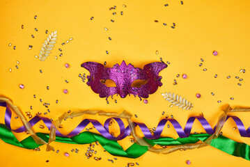 Celebration Mardi Gras, or Fat Tuesday. Carnival masks on yellow background with copy space
