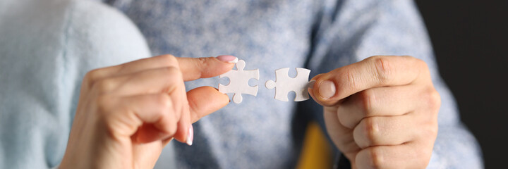 Man and woman connect white puzzles. Relationship psychology concept
