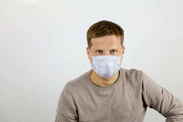 Open gaze of a man wearing a protective medical mask. The concept of health and victory over viruses. Background with place for text