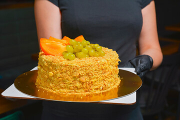 Whole Cake Napoleon served by waiter in cafe or restaurant. Birthday party celebration, eating out...