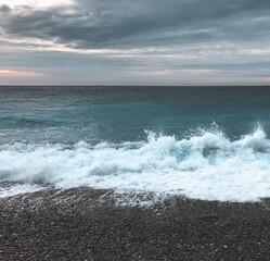 Blue grey pebble seashore ocean waves