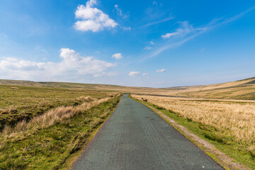 Rural road in the Yorkshire Dales near West Stonesdale, North Yorkshire, England, UK