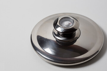 Close-up stainless steel pan lid, isolated on white background.