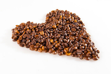 Coffee beans in heart shape as a love symbol. White background isolated