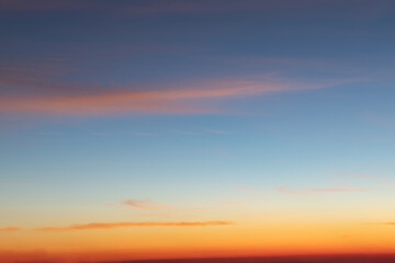 Heaven at early morning with copy space. Sunset, sunrise backdrop.Predawn clear sky with orange horizon and blue atmosphere. Smooth orange blue gradient of dawn sky.