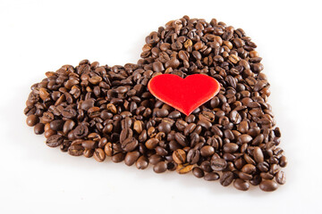 Coffee beans in heart shape with a Small red heart. White background isolated