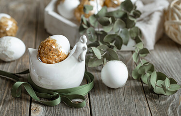 Spring easter composition with eggs and plants on wooden surface close up.