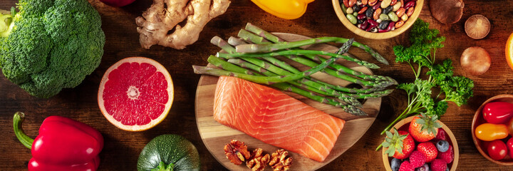 Healthy diet food panorama. Salmon, aspatagus, grapefruit and other superfoods, shot from above