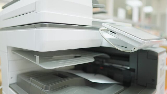 Employees are using copy paper at the office copier.