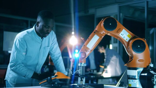 African science worker is digitally operating a robot