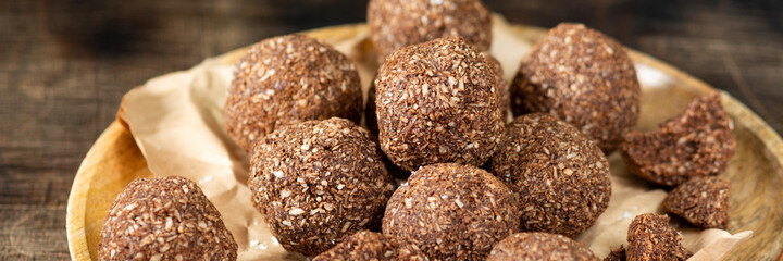 Chocolate coconuts. Chocolate balls with coconut. Chocolate candies or cookies with coconut, cinnamon and powdered sugar
