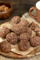 Chocolate coconuts. Chocolate balls with coconut. Chocolate candies or cookies with coconut, cinnamon and powdered sugar	