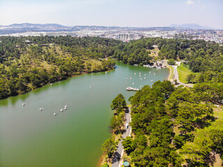 Fototapeta premium Aerial view of Love Valley park in Dalat, Vietnam is one of the most romantic sites of Da Lat city, with many deep valleys and endless pine forests