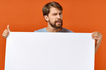 emotional guy holding a white sheet of paper in his hands Poster mockup advertising sign