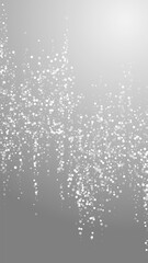 Fototapeta na wymiar Random white dots Christmas background. Subtle flying snow flakes and stars on grey background. Alive winter silver snowflake overlay template. Stylish vertical illustration.