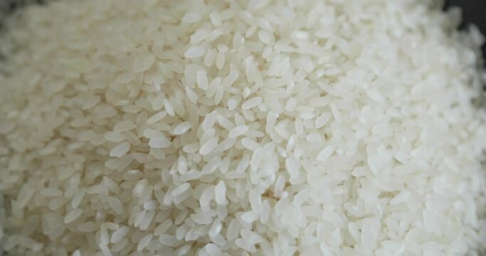 Pile Of White Raw Rice Grains Rotating