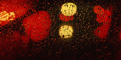 water on window glass, red and yellow abstract