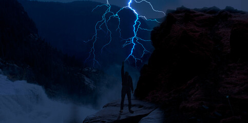 A man holding lighting ,storm in the mountains