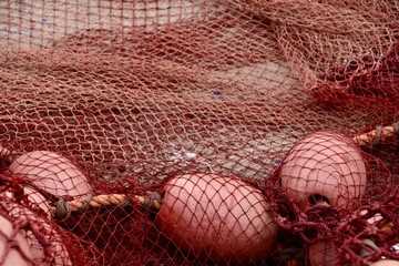 Close up of red commercial fishing nets in Morocco 
